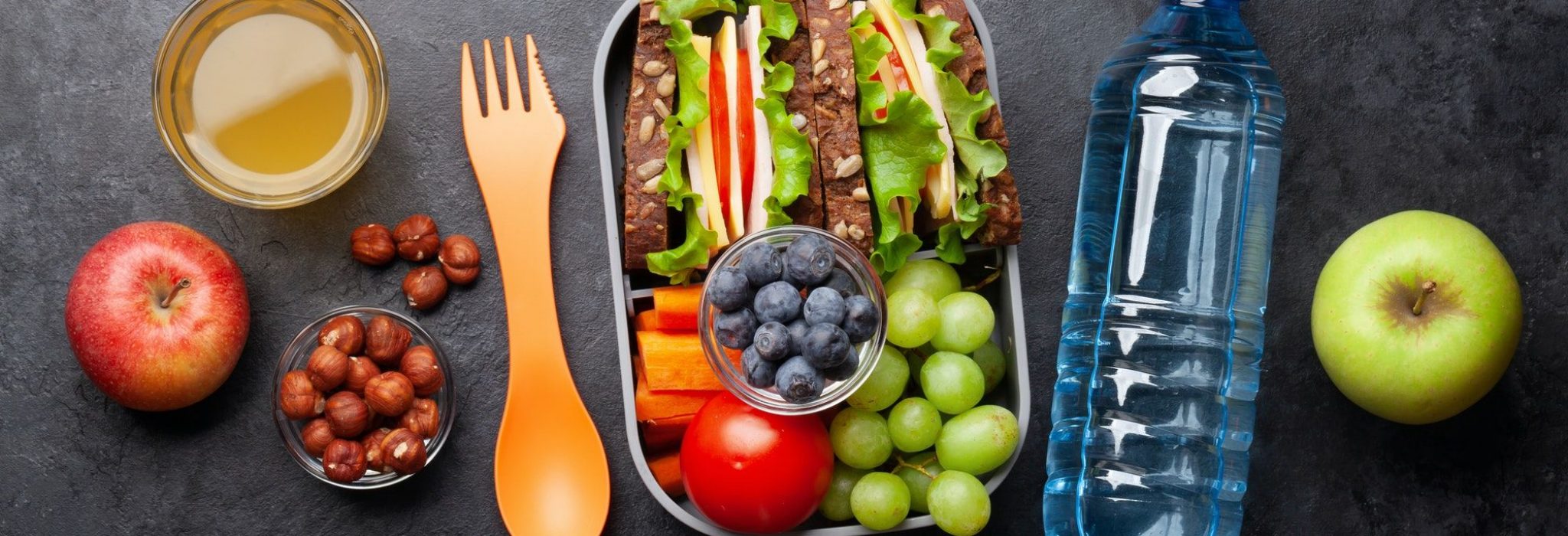 Healthy school lunch box with sandwich and fresh vegetables